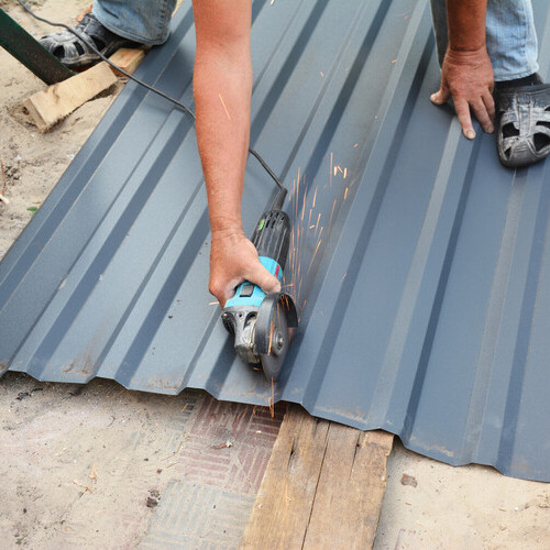worker installing a metal roof