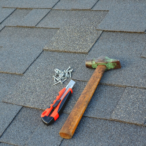 tools laying on top of a shingle roof